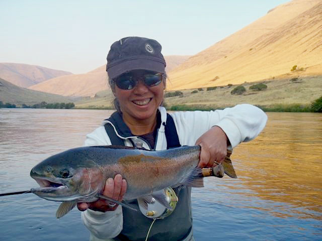 Thuy Tran holding a trout.